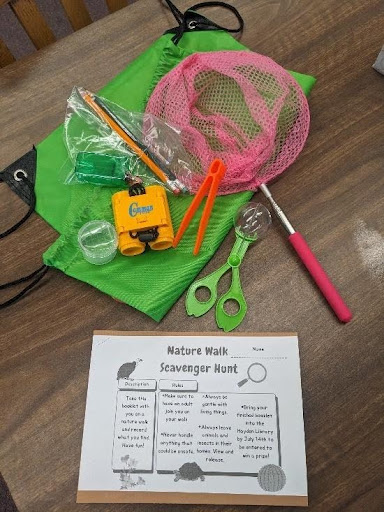 Hayden's Nature Scavenger Hunt tools- a bug catching net, some plastic binnoculars and other items for kids.